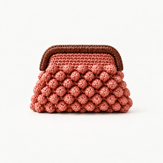 NAXOS BLUSH handmade crochet bobble clutch on off-white background