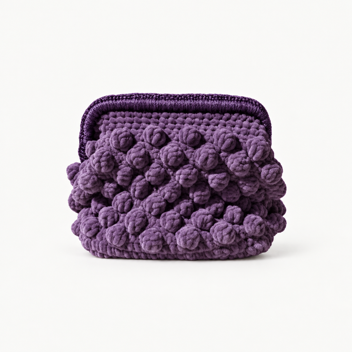 NAXOS PLUM handmade crochet bobble clutch on off-white background