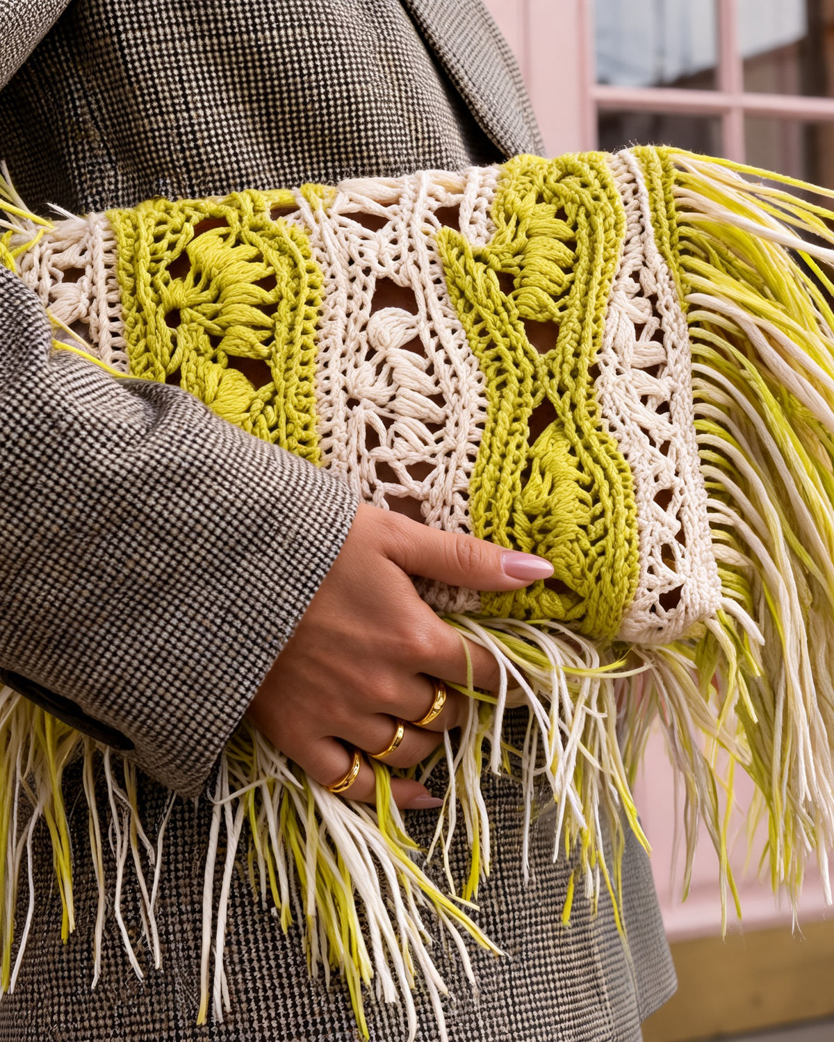 Close-up of the Koukla SAGE clutch crochet texture in chartreuse and cream with raffia fringe